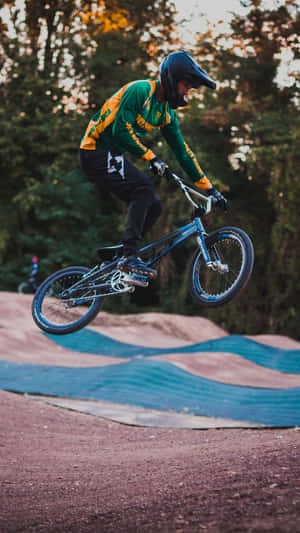 Doing A Tailwhip On A Bmx In The Great Outdoors Wallpaper