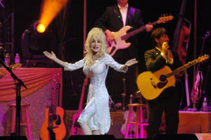 Dolly Parton On Stage With Band Wallpaper