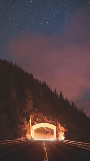 Driving Through A Winding Road Tunnel Wallpaper