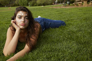 Dua Lipa Lying On Grass Wallpaper