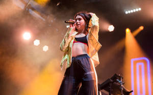 Dua Lipa Performing On Stage Wallpaper