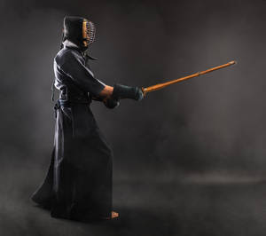 Duel Of Determination - A Kendo Fighter In Action Wallpaper