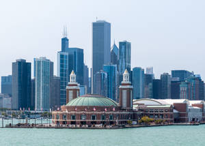 Dusk At Navy Pier - Vibrant City Lights Reflecting Off Lake Michigan Wallpaper