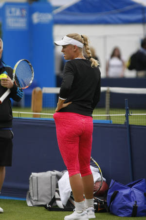 Dynamic Back View Of Tennis Star Caroline Wozniacki Wallpaper