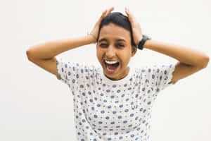 Ecstatic Woman With Raised Hands Celebrating Success Wallpaper