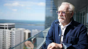 Elderly Man Contemplating Cityscape Wallpaper