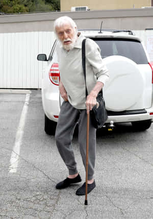 Elderly Man With Cane And Bag Wallpaper