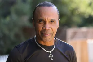 Elderly Ray Leonard Smiling In A Black Shirt Wallpaper