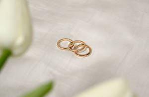 Elegance In Simplicity: Trio Of Rose Gold Rings Wallpaper