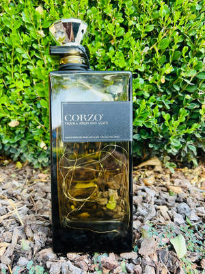 Elegant Bottle Of Corzo Anejo Tequila Wallpaper