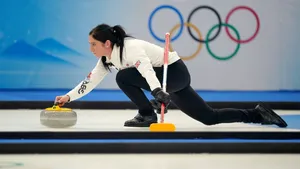 Elegant Female Curling Athlete Wallpaper