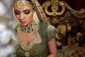 Elegant Indian Bride Adorned In Traditional Jewelry Wallpaper