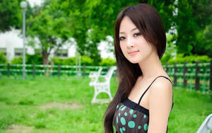 Elegant Japanese Womanin Park Wallpaper