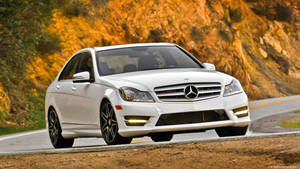 Elegant Mercedes Benz C300 Cruising Into The Sunset Wallpaper