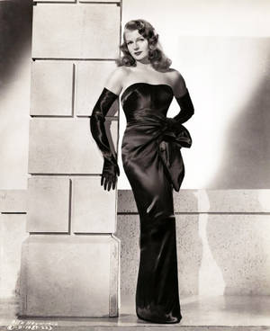 Elegant Rita Hayworth In A Timeless Black Dress Wallpaper