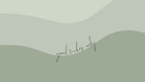 Elegant Sage Green Laptop On A Minimalist Desk Setup Wallpaper