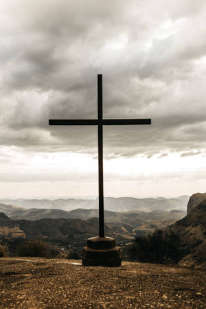 Elegant Wooden Cross Against Sunset Sky Wallpaper