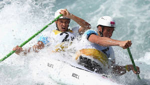 Embrace The Victory - Olympic Canoeists From Canada Celebrating Their Gold Medal Wallpaper