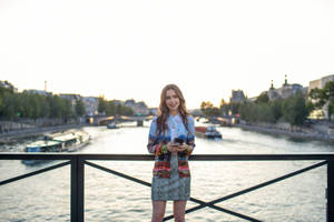 Emily In Paris Stands Out On A Bridge Wallpaper