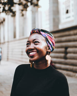 Empowered Black Woman With Vibrant Head Wrap Wallpaper