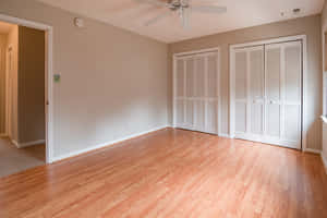 Empty Room With Fan And Cabinets Wallpaper