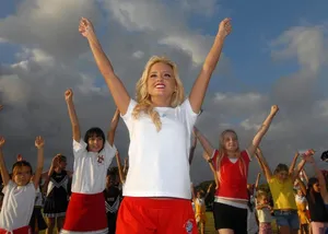 Energetic Cheerleader Hold Pom-poms High Wallpaper
