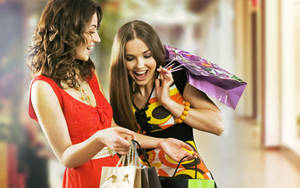 Energetic Shoppers Showing Their Purchase Bags Wallpaper