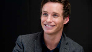 English Actor Eddie Redmayne Posing In A Stylish Suit Wallpaper