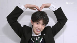 Enhypen Heeseung Doing A Heart Pose Wallpaper