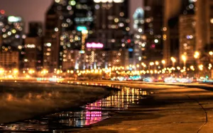 Enjoy A Peaceful Stroll Under The Street Lights Along A Beachside Street Wallpaper