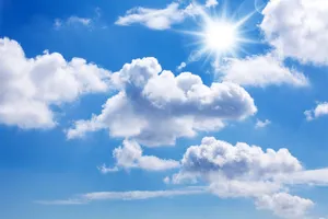 Enjoy An Idyllic View Of White Clouds Against A Blue Sky Wallpaper