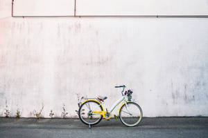 Enjoy Biking With A Yellow City Bike Wallpaper