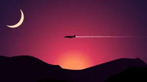 Enjoy The Beauty Of A Plane's Silhouette Against A Peaceful Sunset. Wallpaper
