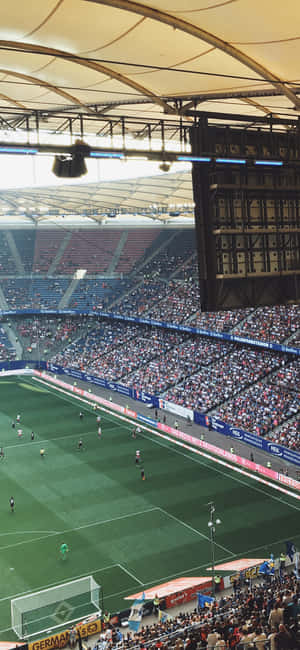 Enjoy The Electrifying Atmosphere Of The Soccer Stadium Wallpaper