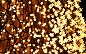 Enjoy The Festive Glow Of Christmas Lights Wallpaper