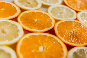 Enjoy The Sweet And Sour Delight Of Orange And Lemon Slices! Wallpaper