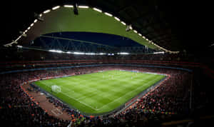 Enjoying A Game Of Soccer At A Stadium Wallpaper