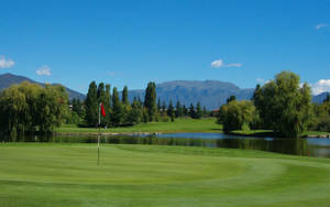 Enjoying A Sunny Day Playing A Round Of Golf Wallpaper