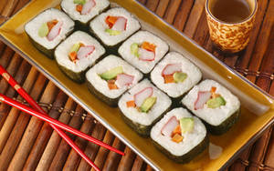 Enjoying Freshly Prepared Sushi In Japan Wallpaper