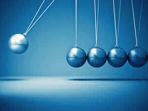 Enthralling Snapshot Of A Blue Pendulum In Motion Wallpaper