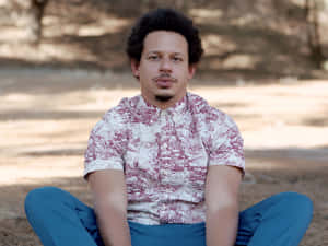 Eric Andre Sitting Outdoors Wallpaper