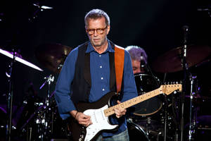 Eric Clapton Performing On Stage Wallpaper