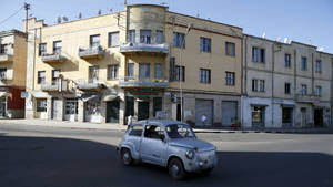 Eritrea Car In Front Of Building Wallpaper