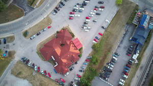 Establishment With Red Roofing And Parking Wallpaper