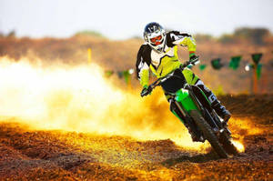 Exciting Action Shot Of Monster Dirt Bike Adventure Wallpaper