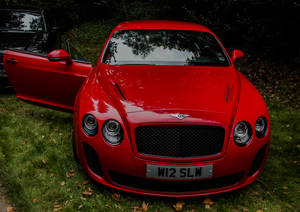 Experience Luxury With The Red Bentley Continental Gt Wallpaper