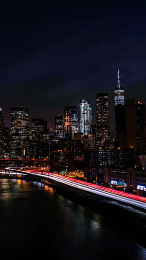 Experience The Magic Of Nyc At Nighttime With This New York City Night Iphone Wallpaper