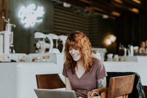 Experienced Woman Working Hard At Her Desk Wallpaper