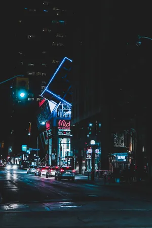 Explore The Bright Lights And Energy Of A Neon-lit City. Wallpaper