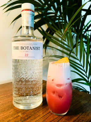 Exquisite Refreshment: The Botanist Dry Gin Cocktail Surrounded By Palm Leaves Wallpaper